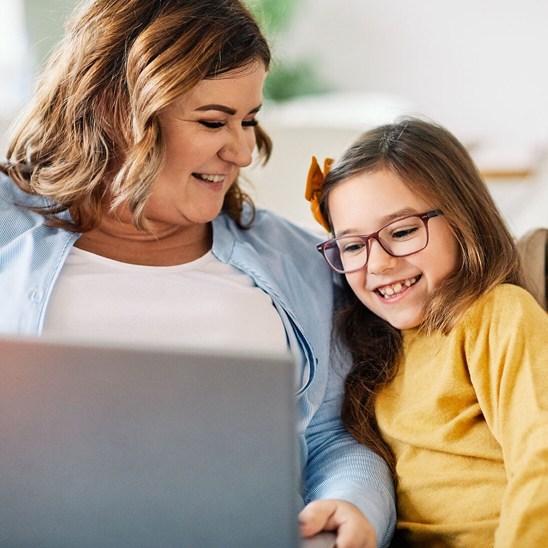 Mother and daughter Having fun with laptop at home